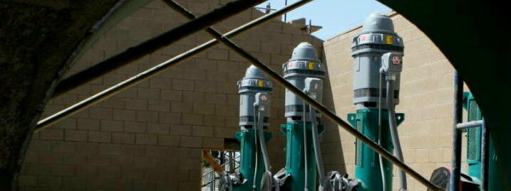 Image of large industrial pumps set up in a construction area, showing a system in its initial stages.